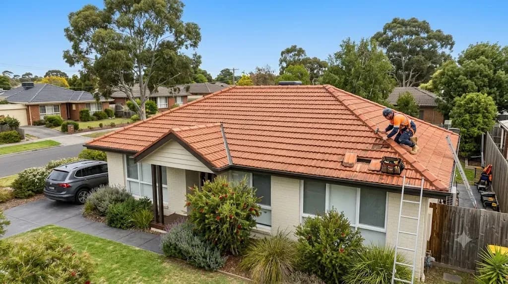 Roof repair cost in Adelaide — tradesperson repairing cracked roof tiles